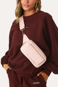 MODEL WEARING BLUSH SQUARE FANNY PACK