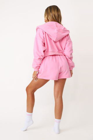 Model wearing the Bubble Gum Pink Kittenish Embroidered full zip.