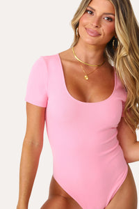 Model wearing the Bubble Gum Pink basics short sleeve bodysuit