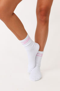 Model wearing pink  logo Kittenish socks.