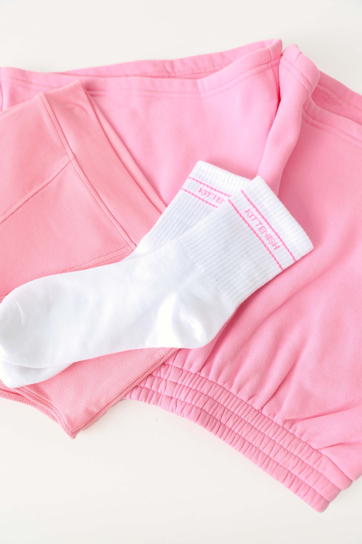 Pink logo Kittenish socks laying over Bubble Gum boy shorts and sweat short.