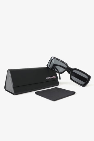 The Ali black square sunglasses, Kittenish case, and cleaning cloth.