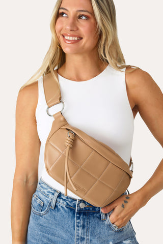 MODEL WEARING THE TAN QUILTED FANNY PACK