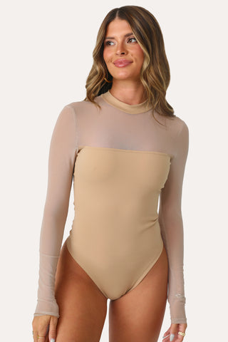 MODEL WEARING OUT ON THE TOWN TAN BODYSUIT.