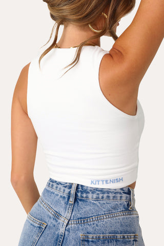 Model wearing White Full Coverage Tank with Blue Logo.