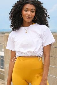 Model wearing the Rookie Crop Shirt with bungees.
