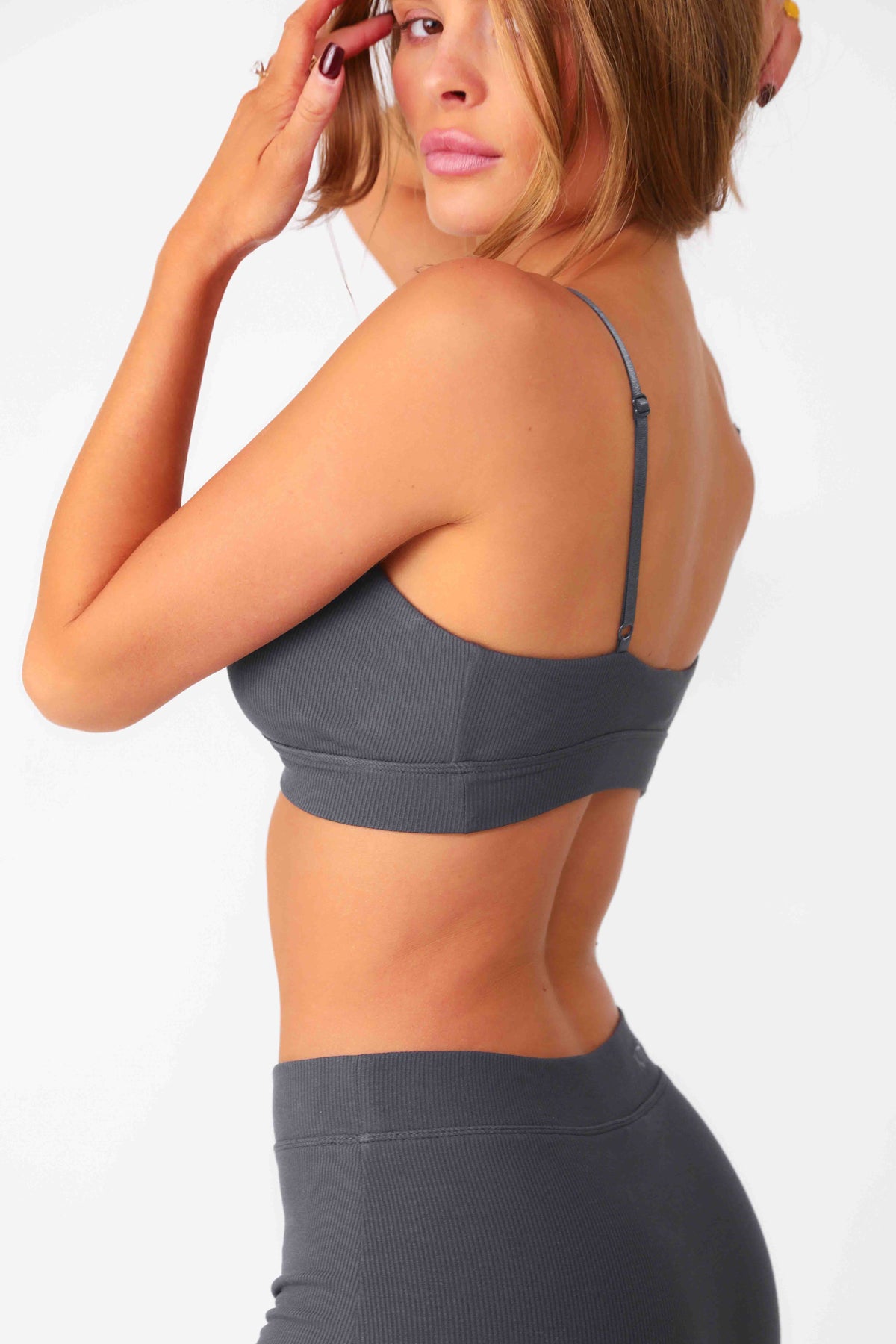 Model wearing Charcoal Ribbed Triangle Bralette, seamless rib fabrication with stretch.