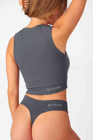 Model wearing Charcoal Full Coverage Rib Bra Tank, stretchy rib knit seamless fabrication, with high scoop neckline and back.