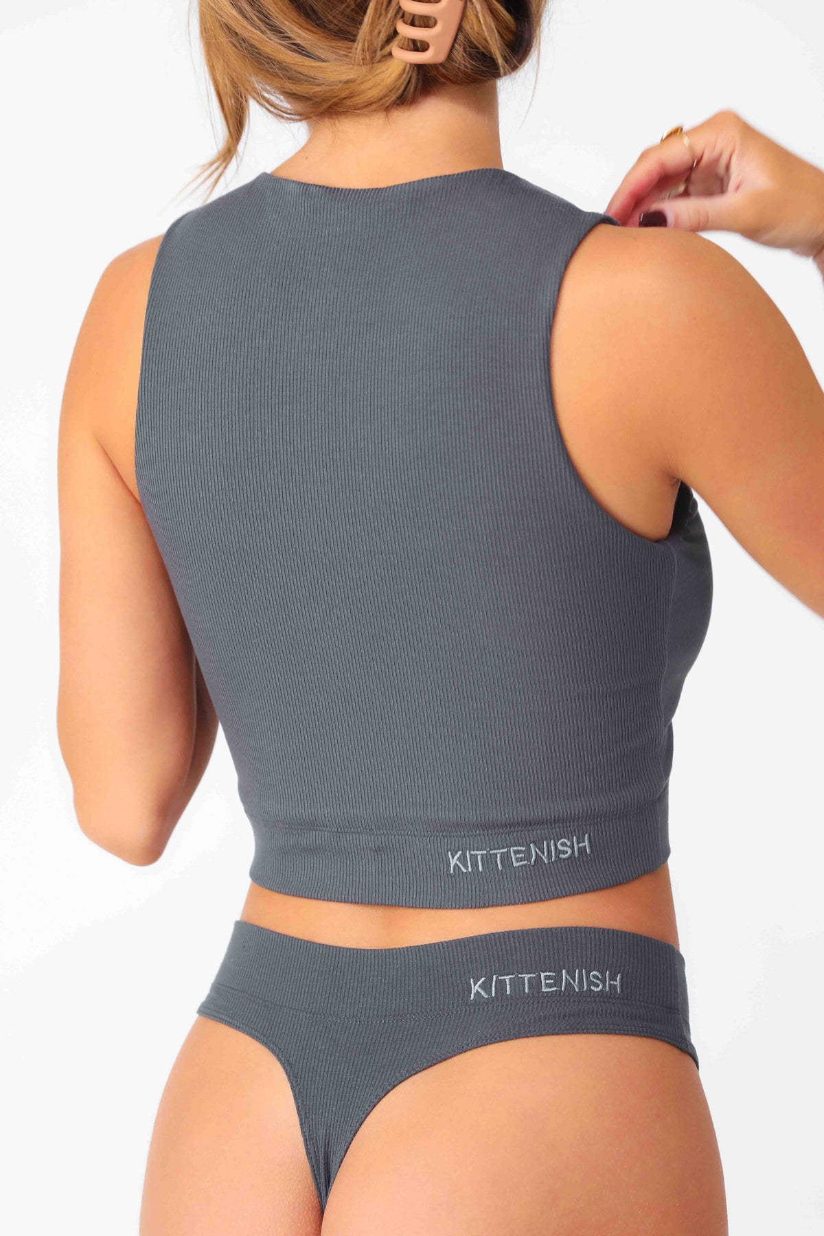 Model wearing Charcoal Full Coverage Rib Bra Tank, stretchy rib knit seamless fabrication, with high scoop neckline and back.