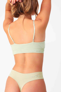 Model wearing Sage Green Ribbed Triangle Bralette, seamless rib fabrication with stretch.