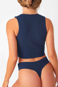 Model wearing Navy Full Coverage Rib Bra Tank, stretchy rib knit seamless fabrication, with high scoop neckline and back.