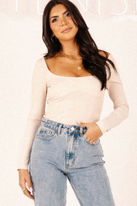 Front view of model wearing Keep It Flirty corset bodysuit, paired with Beau high-rise denim jeans.
