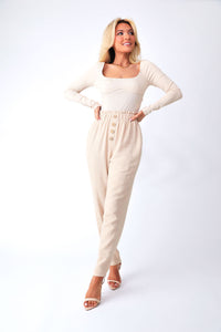 Front view of model wearing Keep It Flirty corset bodysuit, paired with Sweetie Pie linen pants.