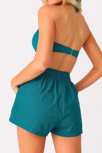 Close up back view of model wearing the Cool Breeze Linen shorts and the On The Rocks bandeau top.