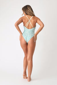 Full body back view of model wearing the Dive Deep one piece.