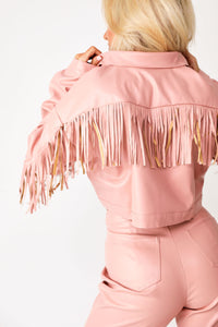 Close up back image of model wearing pink Tatum Mae faux leather cropped fringe jacket with matching pink faux leather Tatum Mae pants.
