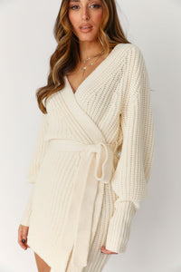 Model wearing Cream Wrap Cardigan Sweater Dress. Adjustable Tie Belt, Long Sleeves, Mini Length, No Hardware