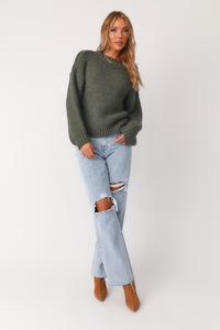 Full body front  view if mode wearing the Rowena Green sweater with the Lacy high rise denim jeans.