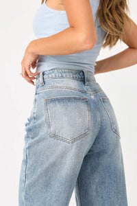 Back view of model wearing the Daisy Distressed jeans.