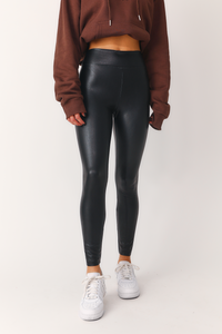 Front view of model wearing 'Bet On Me' black faux leather leggings.